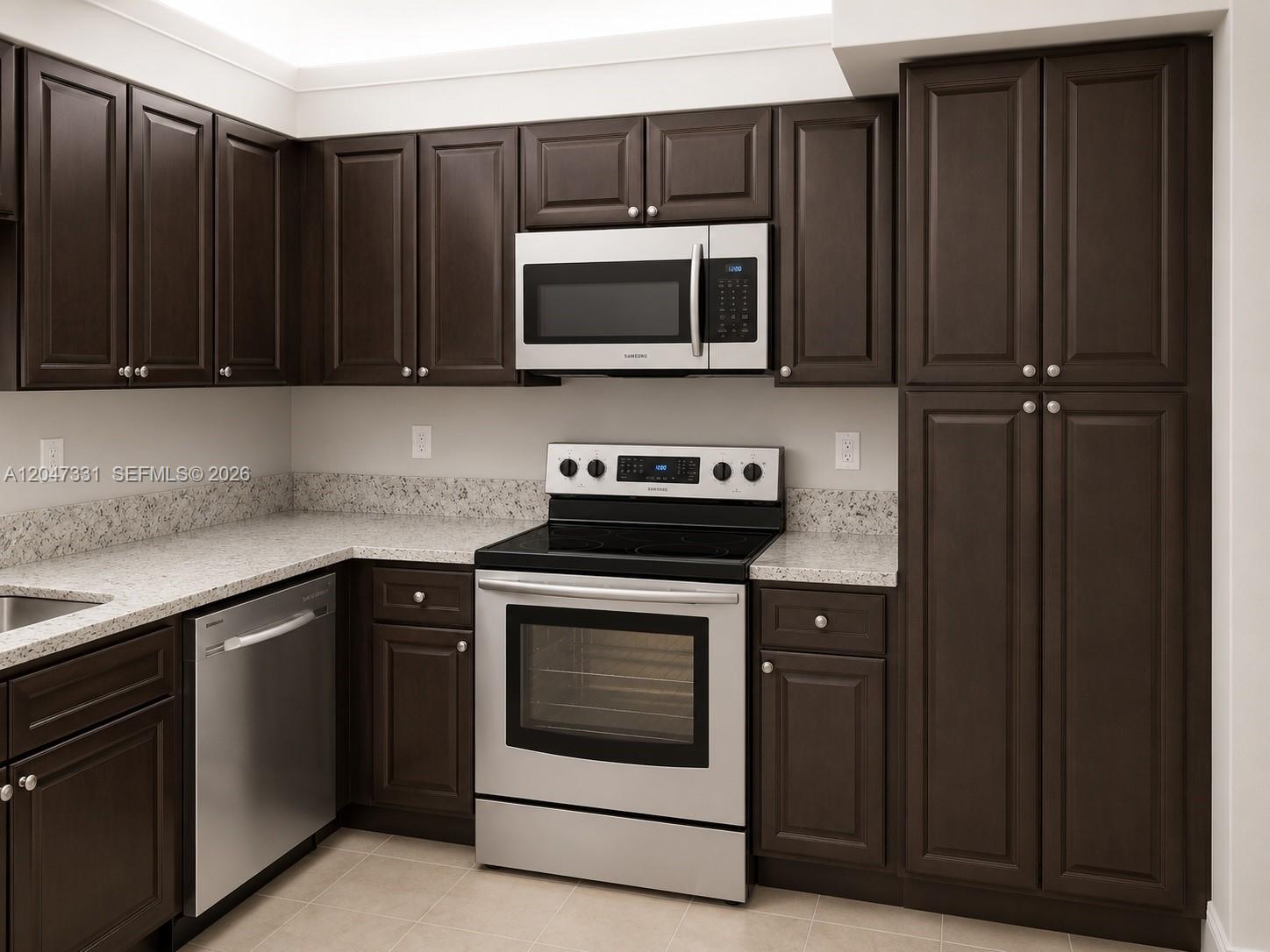 A kitchen features dark wood cabinets, stainless steel appliances, and light-colored speckled countertops — 331 Lakeview Dr # 203, Weston FL 33326, WESTON, FL