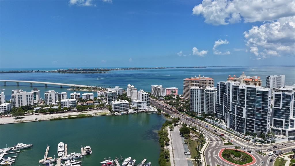 An aerial view of a coastal city with high-rise buildings, a bridge, and a marina — 1111 N GULFSTREAM AVENUE UNIT PH-C, SARASOTA, FL
