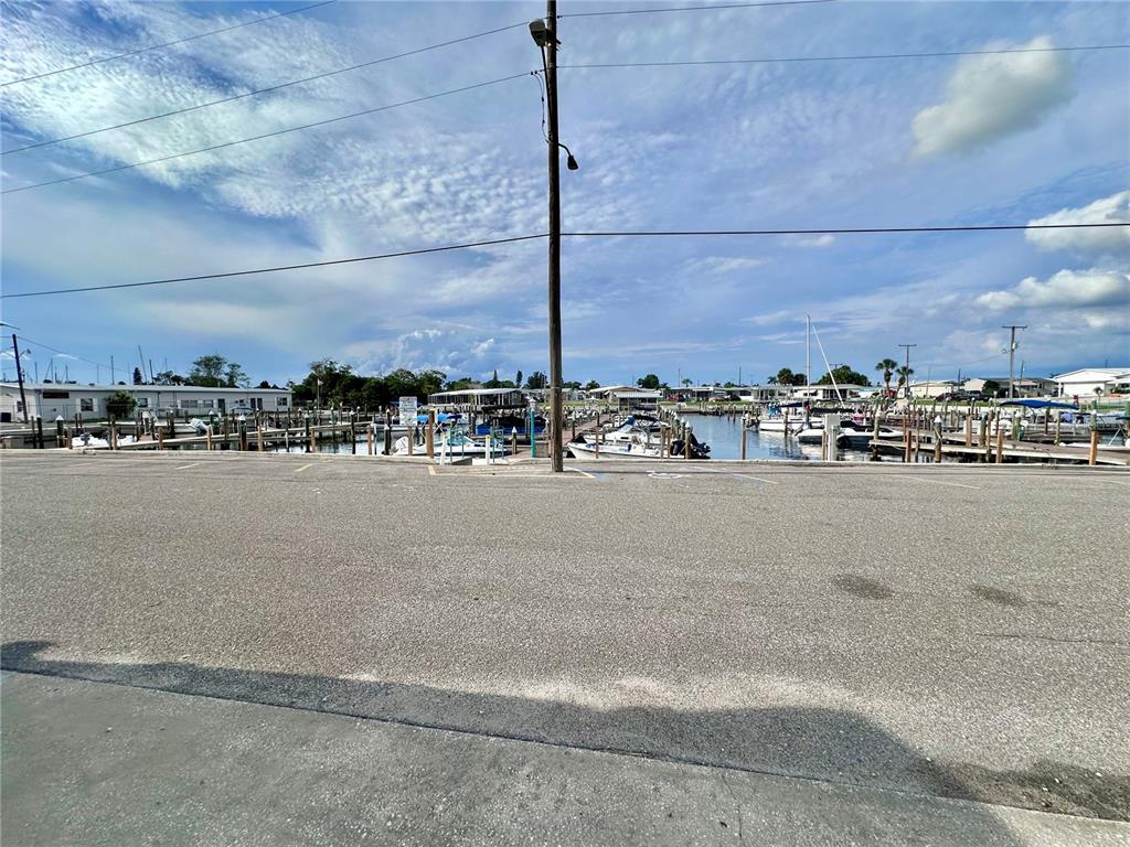 A paved parking lot overlooks a marina filled with docked boats under a cloudy sky — 2208 PENNSYLVANIA AVENUE, BRADENTON, FL