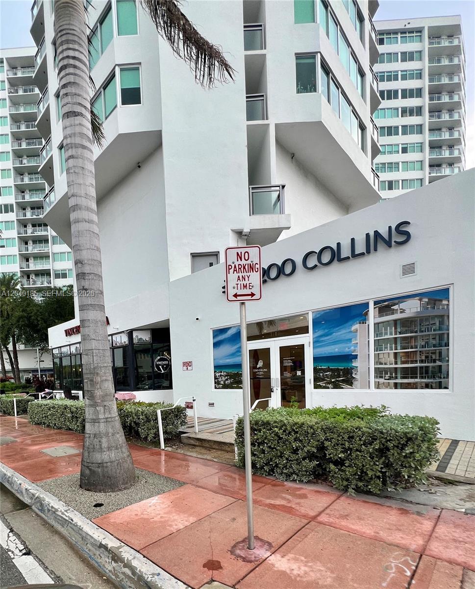 The exterior of a white multi-story building features a no parking sign and landscaping — 7135 Collins Ave # 1523, Miami Beach FL 33141, MIAMI BEACH, FL