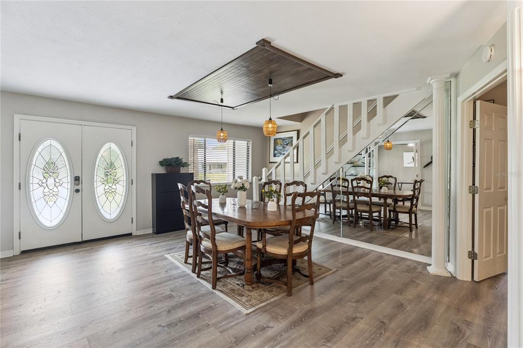 A dining room features a wooden ceiling accent, pendant lights, and a mirrored wall — 537 PELICAN BAY DRIVE, DAYTONA BEACH, FL