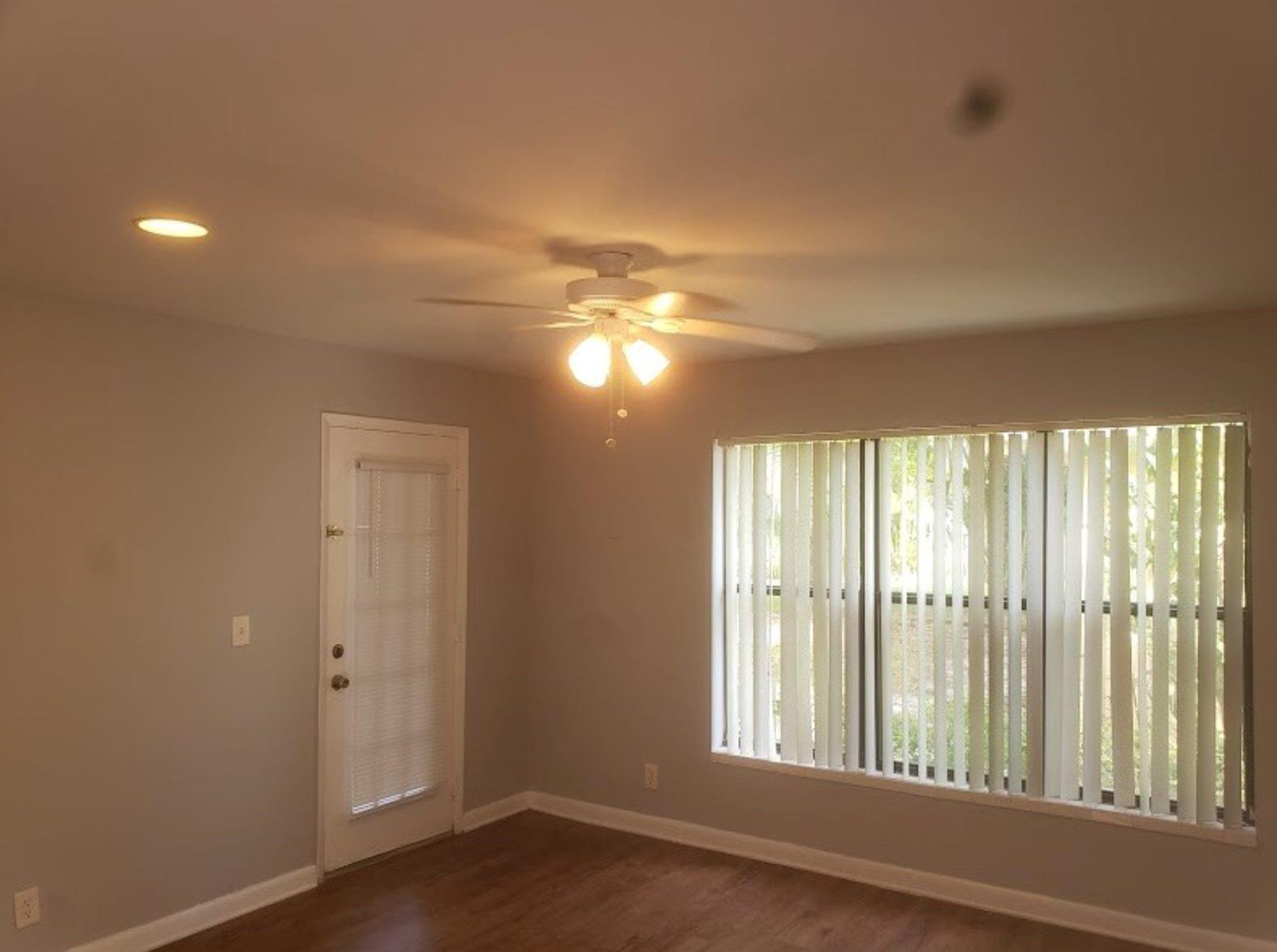 A room with light gray walls, wood-look flooring, a ceiling fan, and vertical window blinds — 4096 N Pine Island Road # 2102, Sunrise FL 33351, SUNRISE, FL
