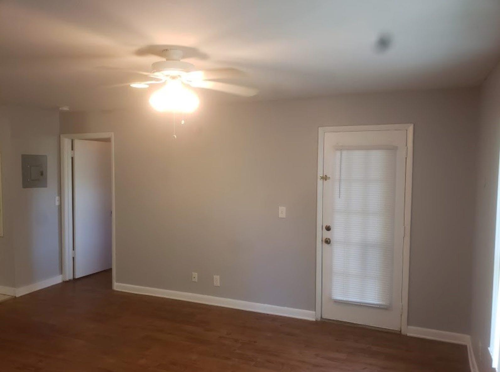 An empty room with light gray walls, wood-look flooring, a ceiling fan, and a door — 4096 N Pine Island Road # 2102, Sunrise FL 33351, SUNRISE, FL