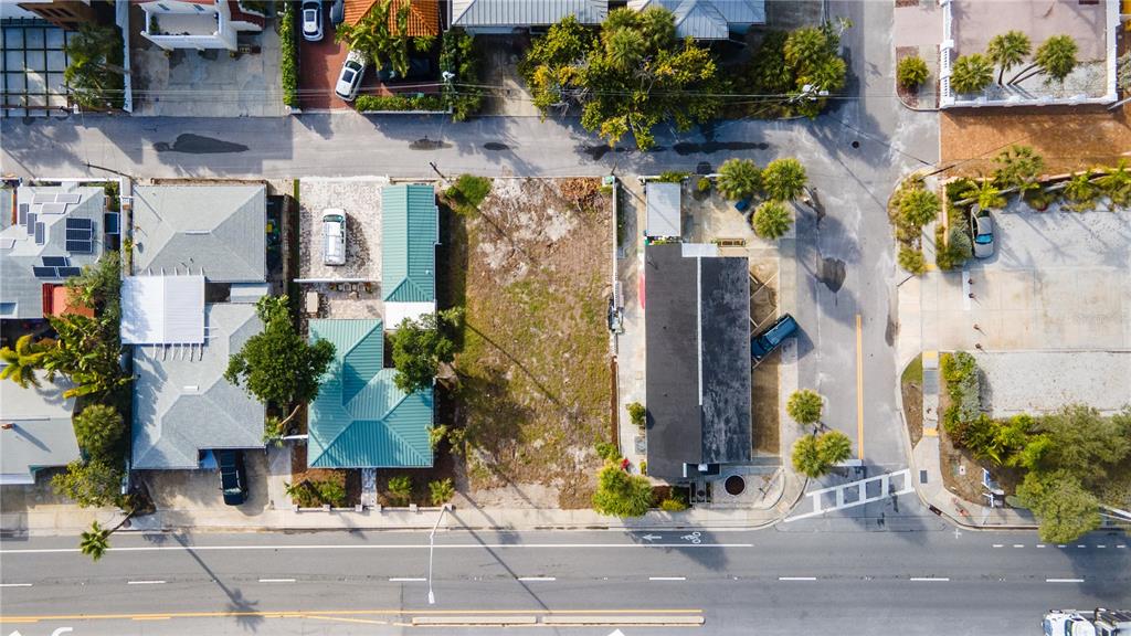 An aerial view shows a vacant lot outlined in red near a sandy beach — 3614 GULF BOULEVARD, ST PETE BEACH, FL