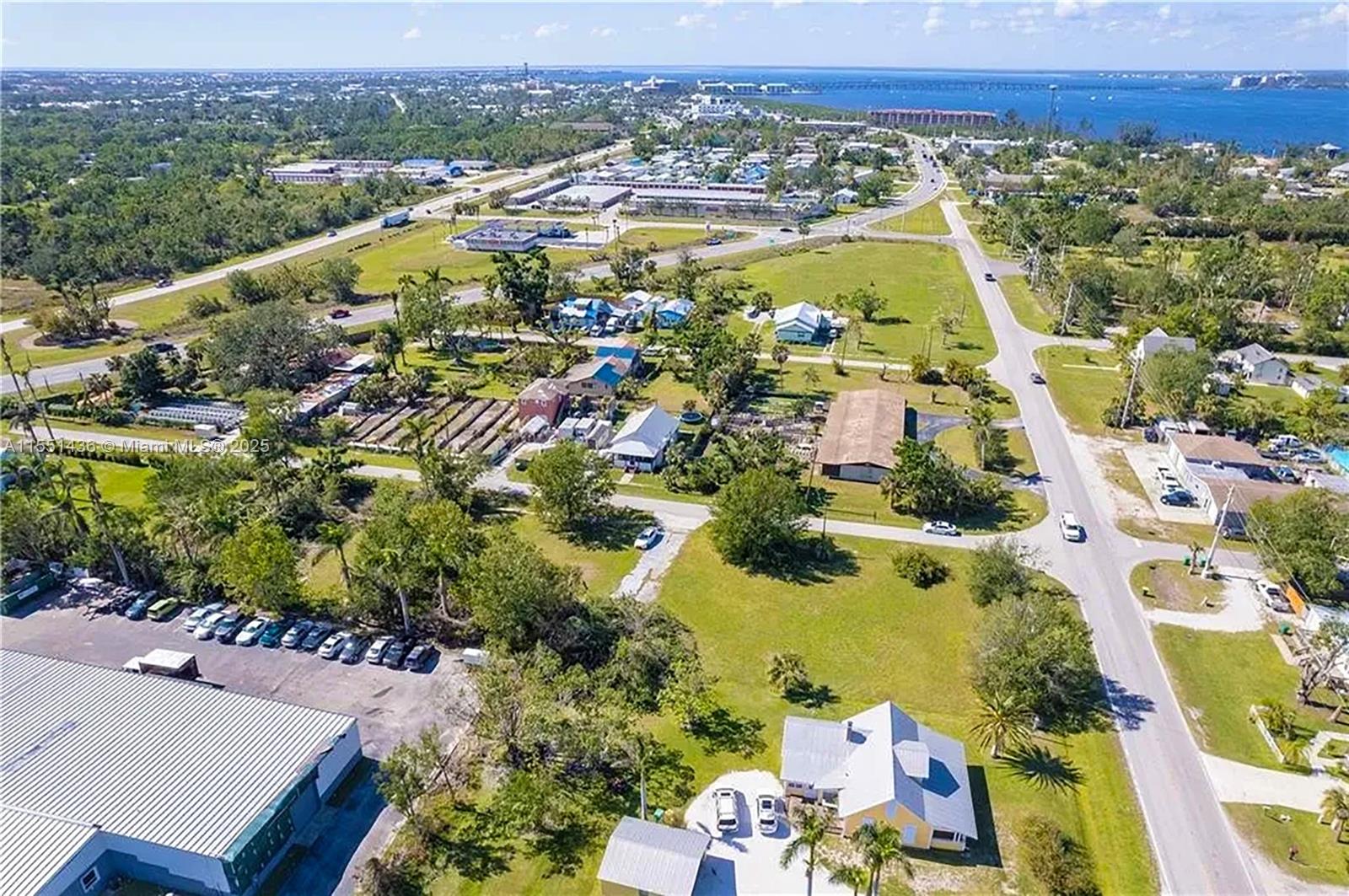 An aerial view shows a residential property with a house, parking area, and surrounding landscape — 514 SOLANA LOOP, Punta Gorda FL 33950, PUNTA GORDA, FL