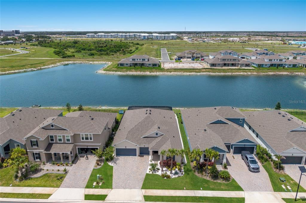 A single-story house with a paved driveway, two garage doors, and a landscaped front yard — 7466 SEA MANATEE STREET, PARRISH, FL