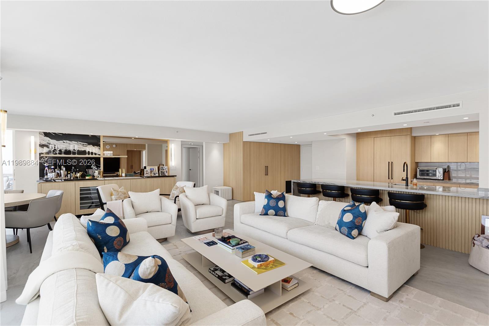 A modern open-concept living room features a white sofa, armchairs, and a kitchen island — 1800 Sunset Harbour Dr, Miami Beach FL 33139, MIAMI BEACH, FL