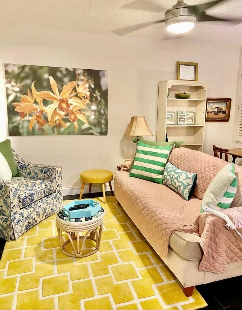 A living room features a yellow geometric rug, a pink sofa, and a floral armchair — 30 S J Street # 14, FL 33460, FL