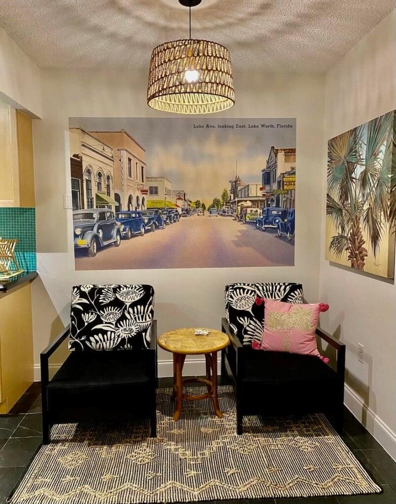 A seating area features two patterned armchairs, a small round table, and wall art — 30 S J Street # 14, FL 33460, FL