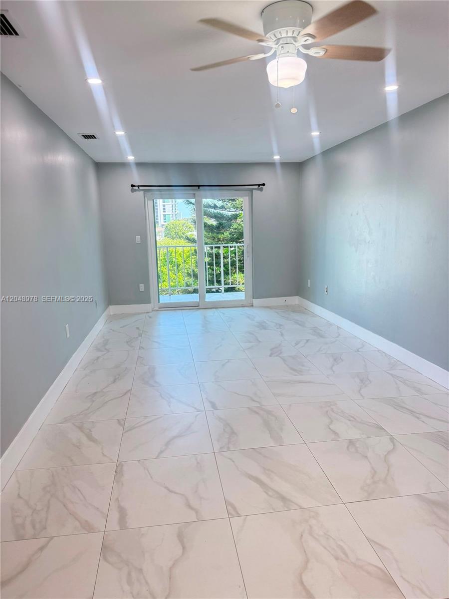 A room with light gray walls, white marble-patterned tile flooring, and a ceiling fan — 453 SW 2nd St # 306C, Miami FL 33130, MIAMI, FL
