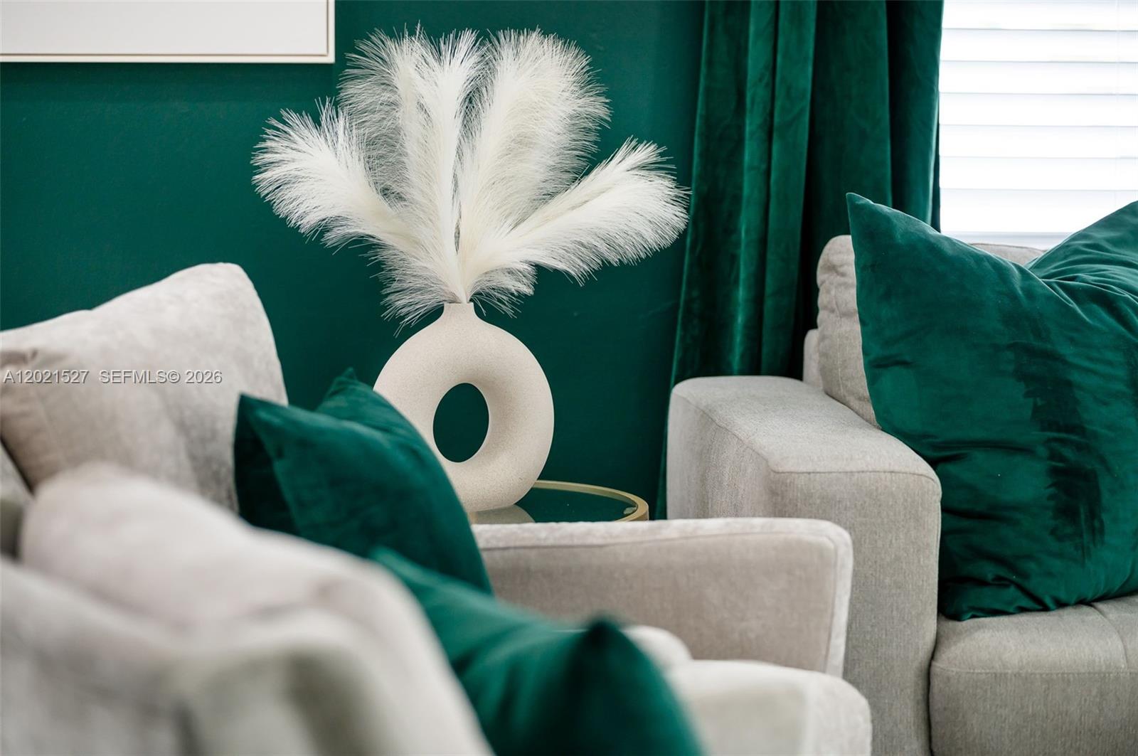 A white donut-shaped vase with feathery stems sits between two gray armchairs against a green wall — 329 SE 12th Ave # 1, Pompano Beach FL 33060, POMPANO BEACH, FL