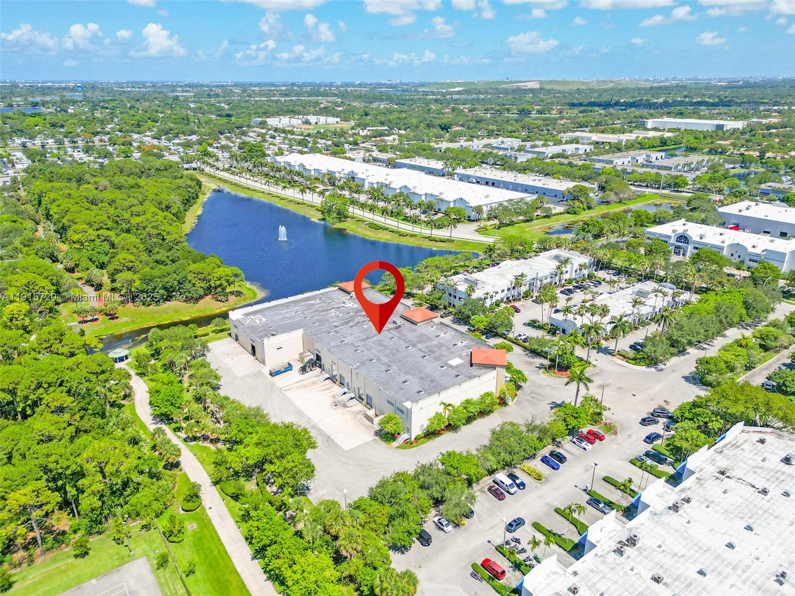 An aerial view shows a large commercial warehouse building with a red location pin marker — 6850 Lyons Technology Cir, Coconut Creek FL 33073, COCONUT CREEK, FL