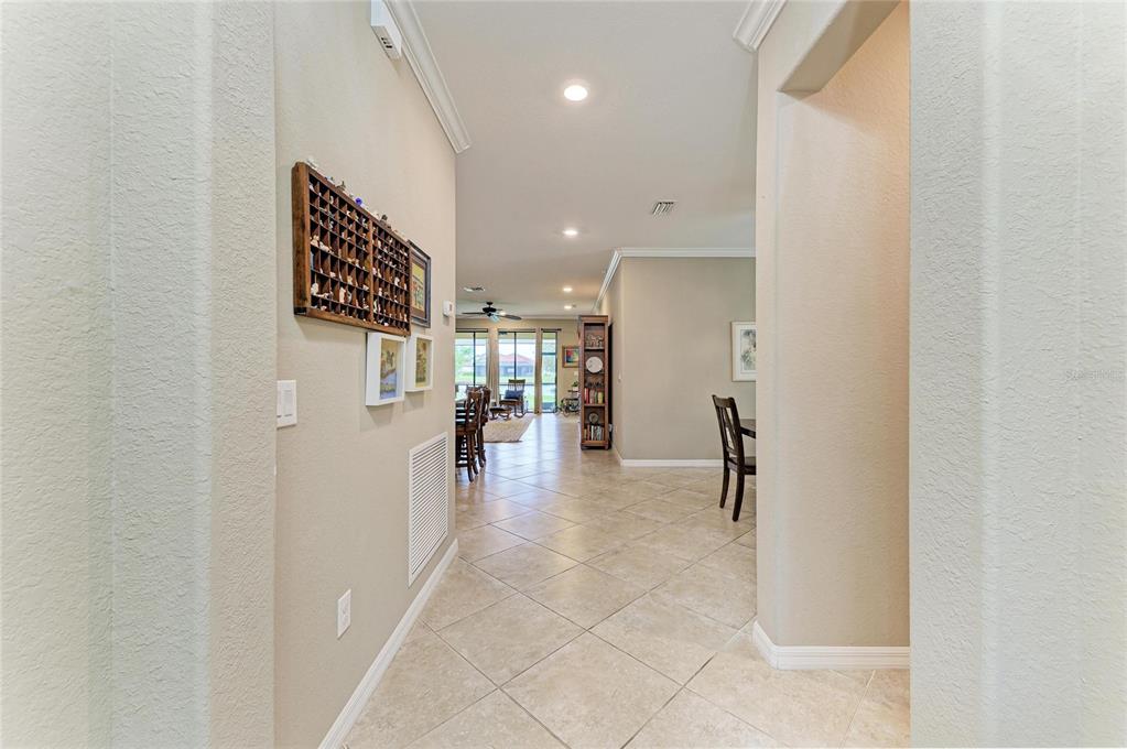 A tiled entryway leads into an open-concept living area with a view of the outdoors — 3512 SAVANNA PALMS COURT, BRADENTON, FL