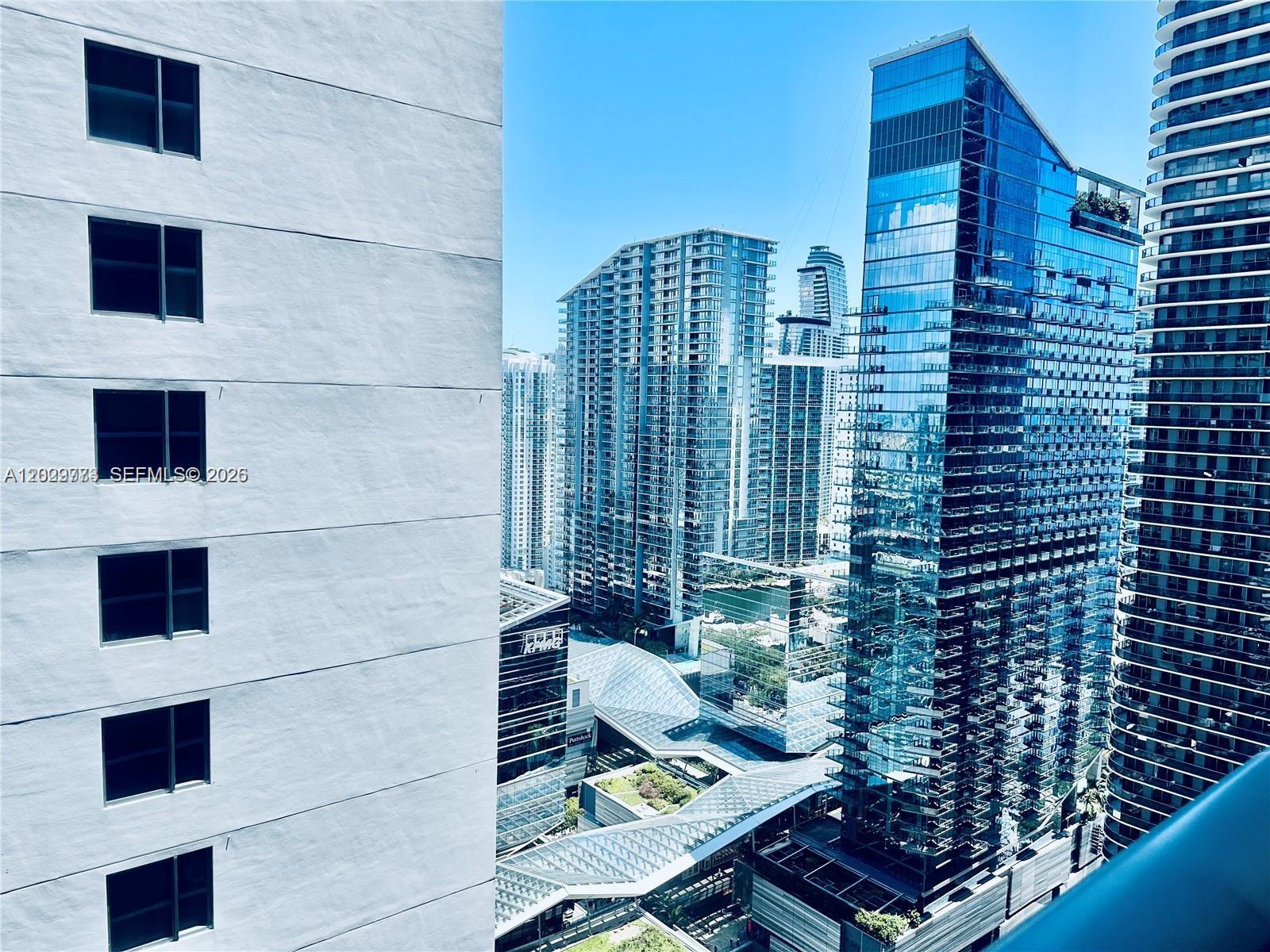 This view shows a dense urban skyline with modern glass skyscrapers and a white building — 55 SW 9th St # 3409, Miami FL 33130, MIAMI, FL