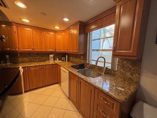 A kitchen with wood cabinets, granite countertops, a stainless steel sink, and tile flooring — 107 Flanders, Delray Beach FL 33484, DELRAY BEACH, FL