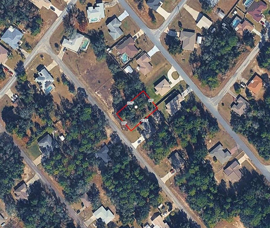 An aerial view shows a vacant, rectangular residential lot outlined in red among suburban homes — 9155 N HAMMOND WAY, CITRUS SPRINGS, FL