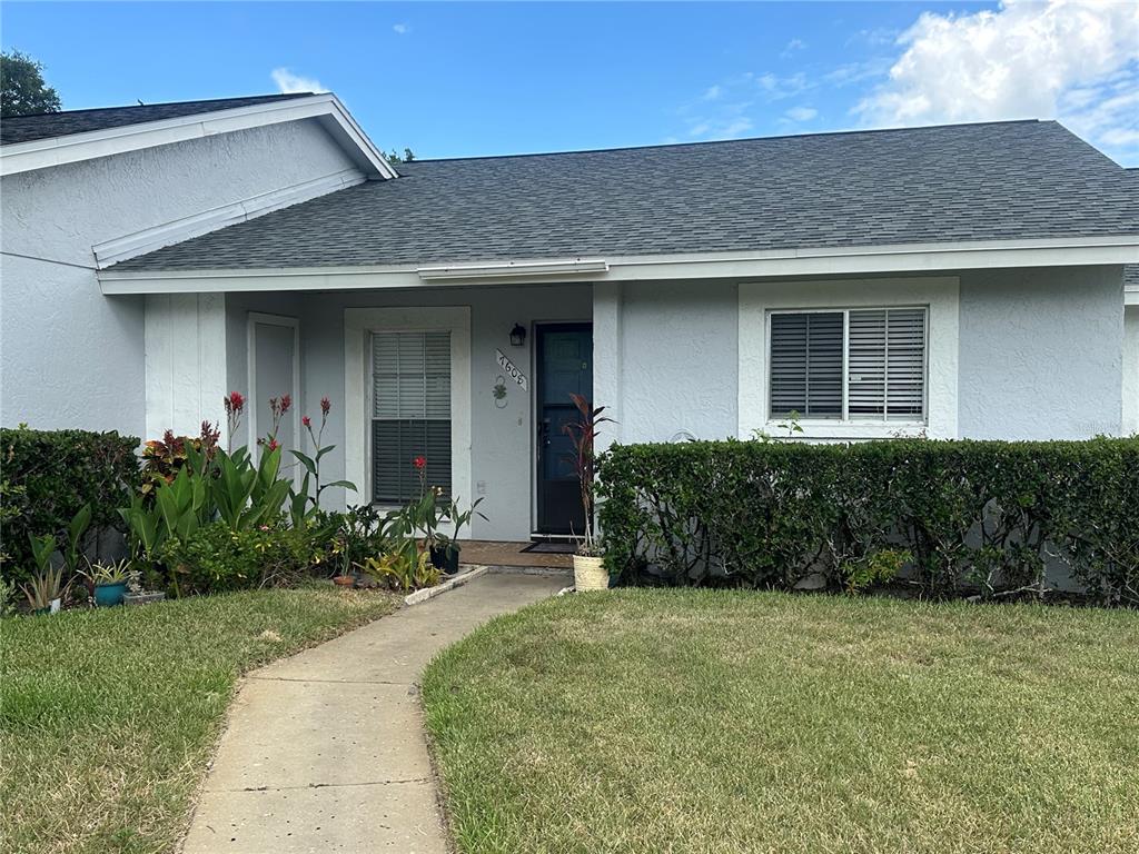 A single-story house with a gray exterior, a shingled roof, and a front walkway — 7608 DANUBE DRIVE UNIT B, HUDSON, FL