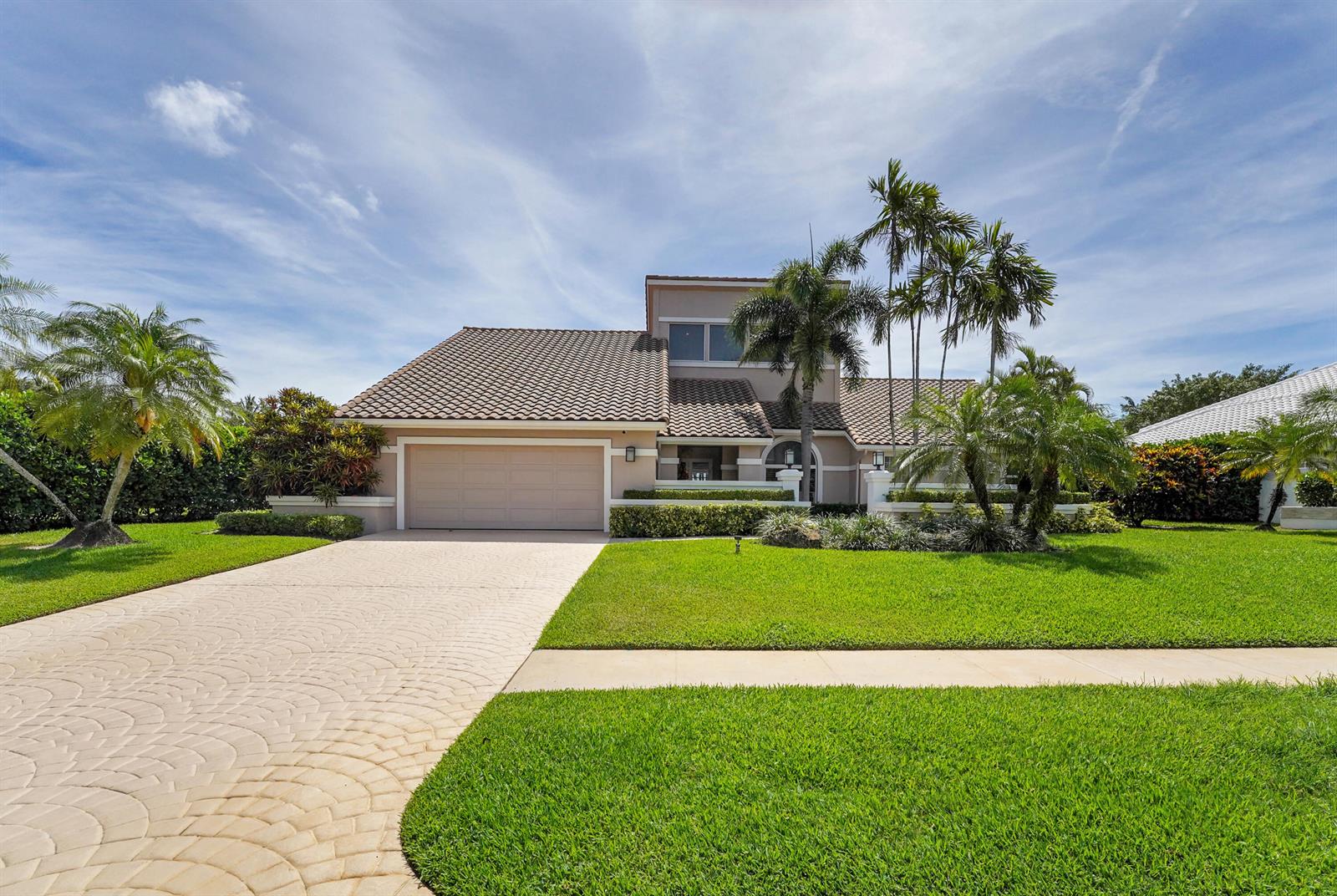 A two-story house with a tiled roof, a two-car garage, and palm trees in front — 4961 Bocaire Boulevard, Boca Raton FL 33487, BOCA RATON, FL