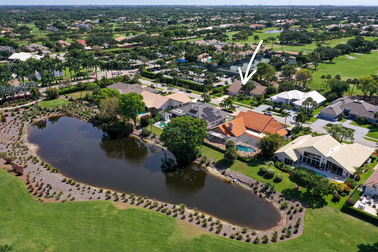 An aerial view shows a residential neighborhood with houses, a pond, and a golf course — 4961 Bocaire Boulevard, Boca Raton FL 33487, BOCA RATON, FL