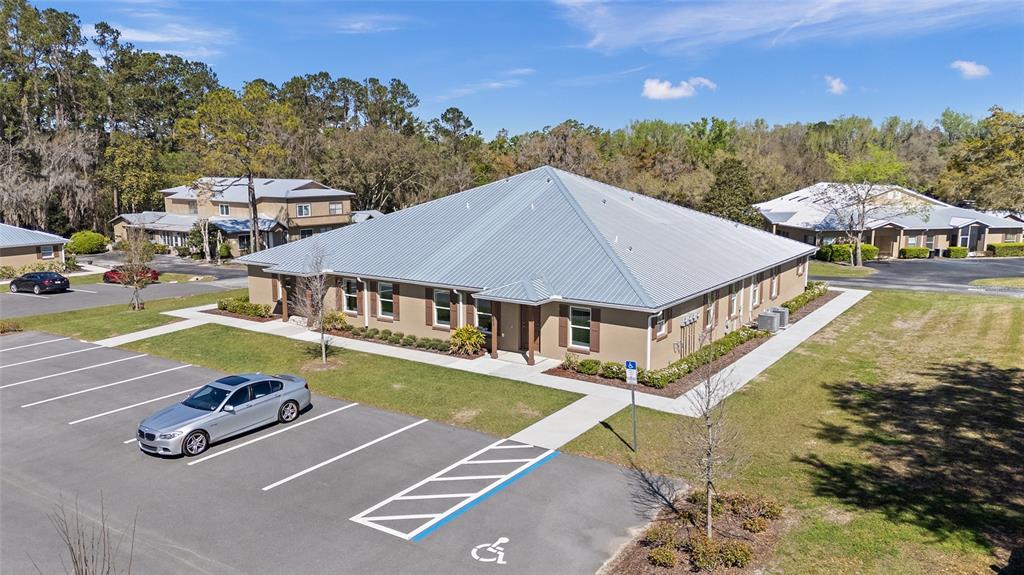 An aerial view of a single-story commercial building with a metal roof and parking lot — 7462 NW 44TH LANE, OCALA, FL