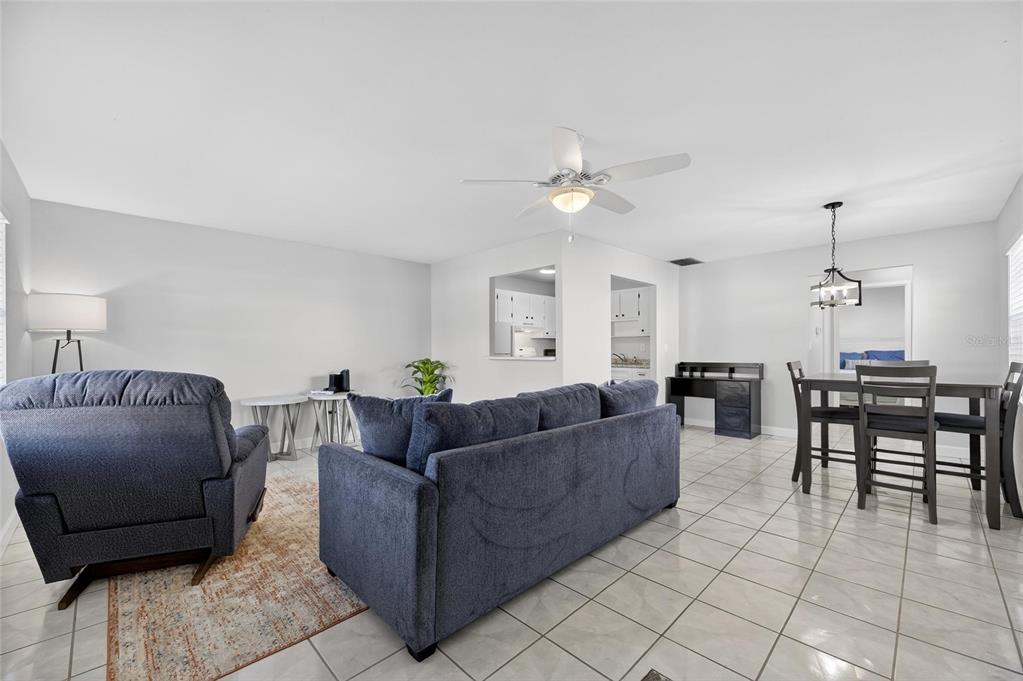 A living and dining area with tile floors, a ceiling fan, and blue furniture — 301 ANDOVER PLACE S UNIT 171, SUN CITY CENTER, FL