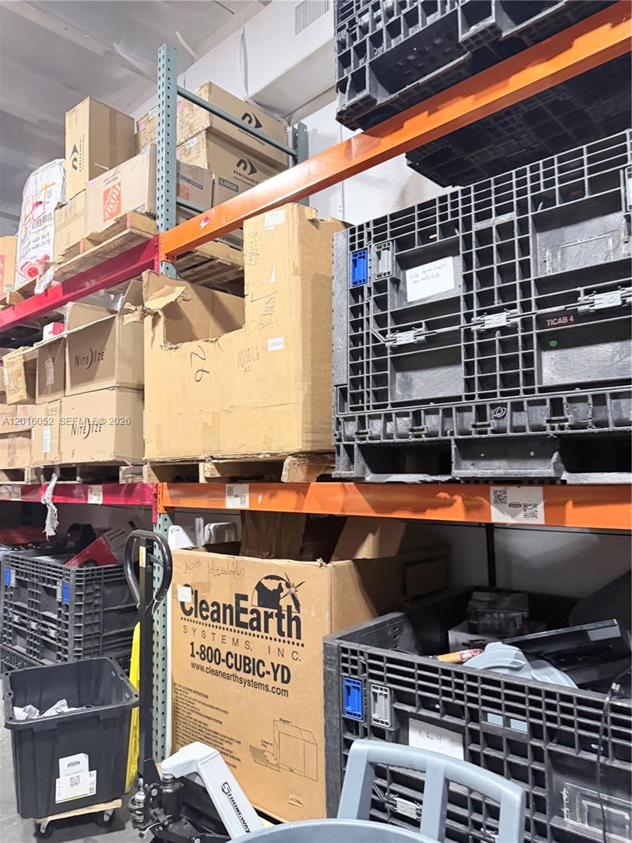 A warehouse storage area features metal shelving units stacked with cardboard boxes and plastic crates — 188, Cutler Bay FL 33157, CUTLER BAY, FL