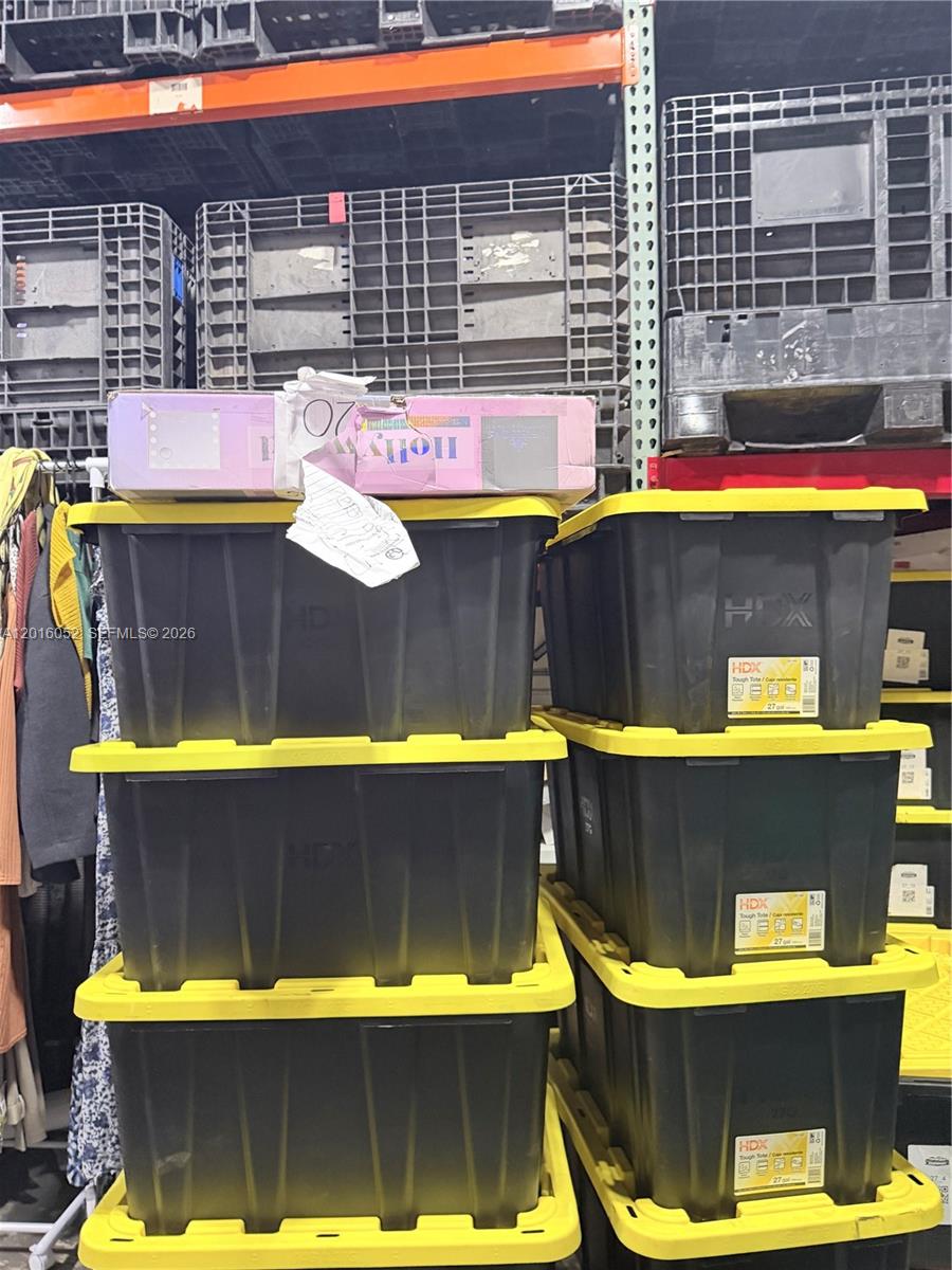 Stacked black storage bins with yellow lids sit in a warehouse-style storage area — 188, Cutler Bay FL 33157, CUTLER BAY, FL