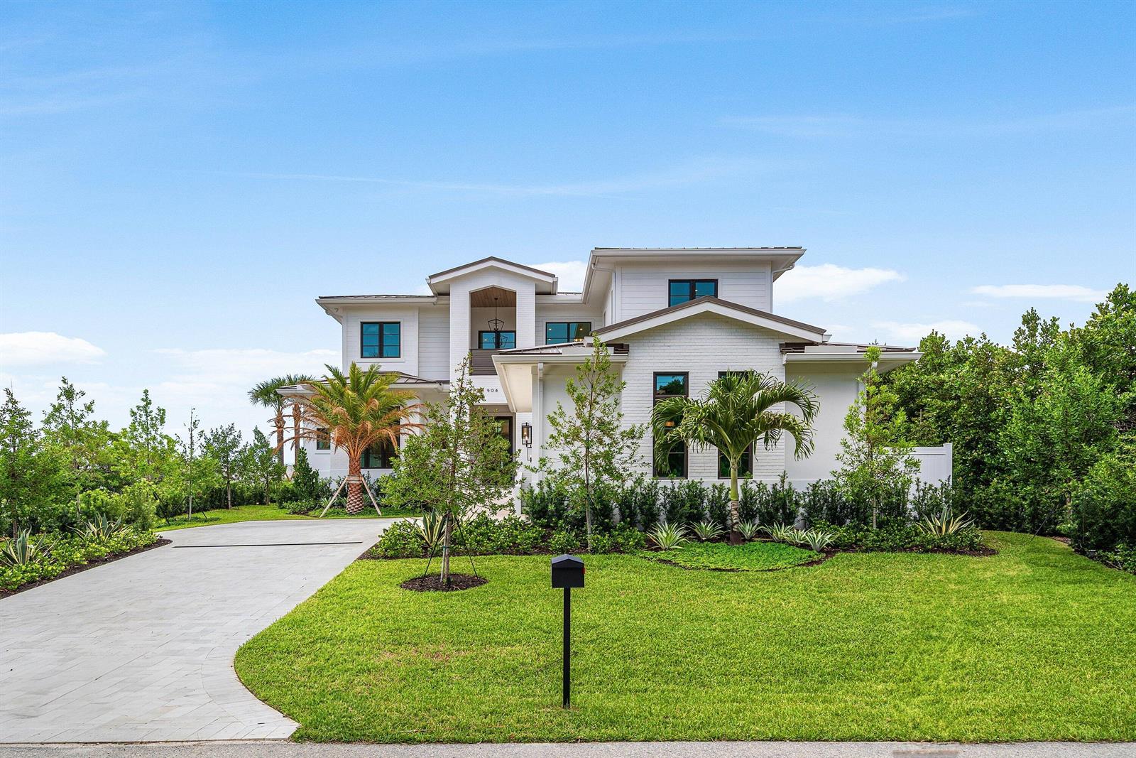 A two-story white house with a paved driveway and palm trees in the front yard — 908 N Atlantic Drive, Lantana FL 33462, LANTANA, FL