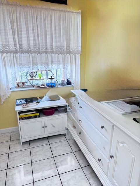 A room with white tile floors, a window with lace curtains, and two white cabinets — 7320 Lake Circle Drive # 407, Margate FL 33063, MARGATE, FL