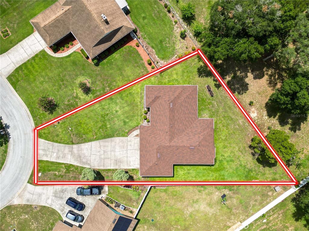 An aerial view shows a single-story house with a brown roof on a large lot — 717 CEDAR KNOLL DRIVE S, LAKELAND, FL