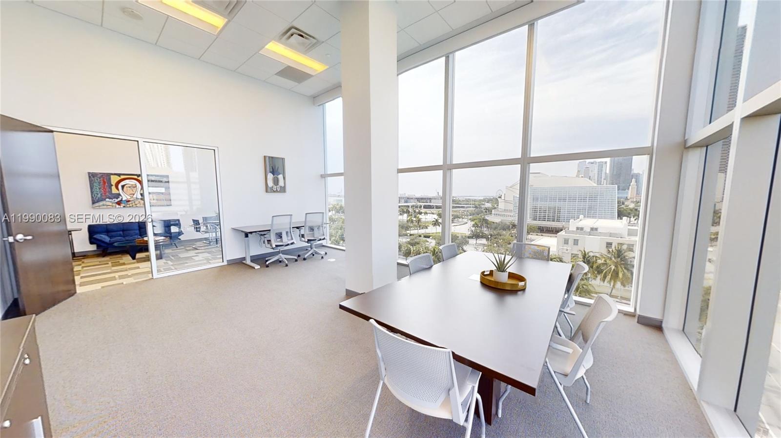 An office space features a conference table, floor-to-ceiling windows, and an adjacent glass-enclosed room — 1501 Biscayne Blvd # 5C, Miami FL 33132, MIAMI, FL