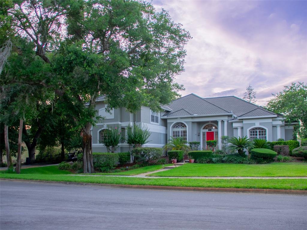 A two-story house with a gray exterior, a red front door, and a manicured lawn — 600 CHOCKTAW STREET, LAKE MARY, FL