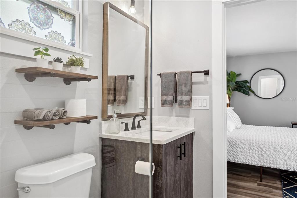 A white door with a keypad lock opens to an interior staircase with wood flooring — 4015 10TH AVENUE N UNIT B, ST PETERSBURG, FL