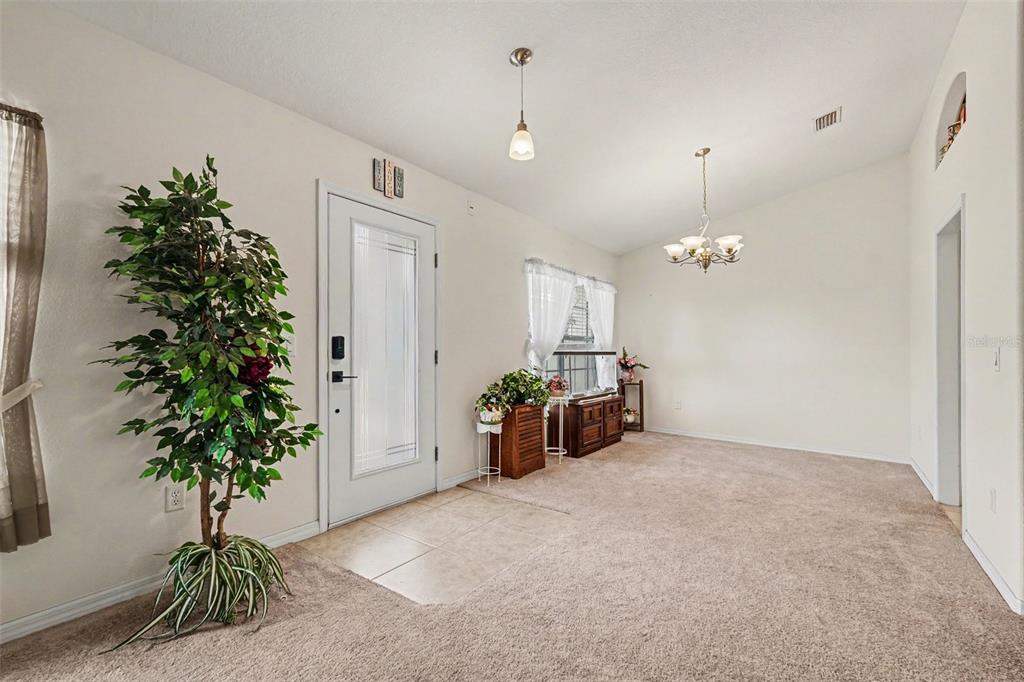 A spacious living room features a pool table, neutral furniture, and vaulted ceilings — 11177 MIRAGE AVENUE, BROOKSVILLE, FL