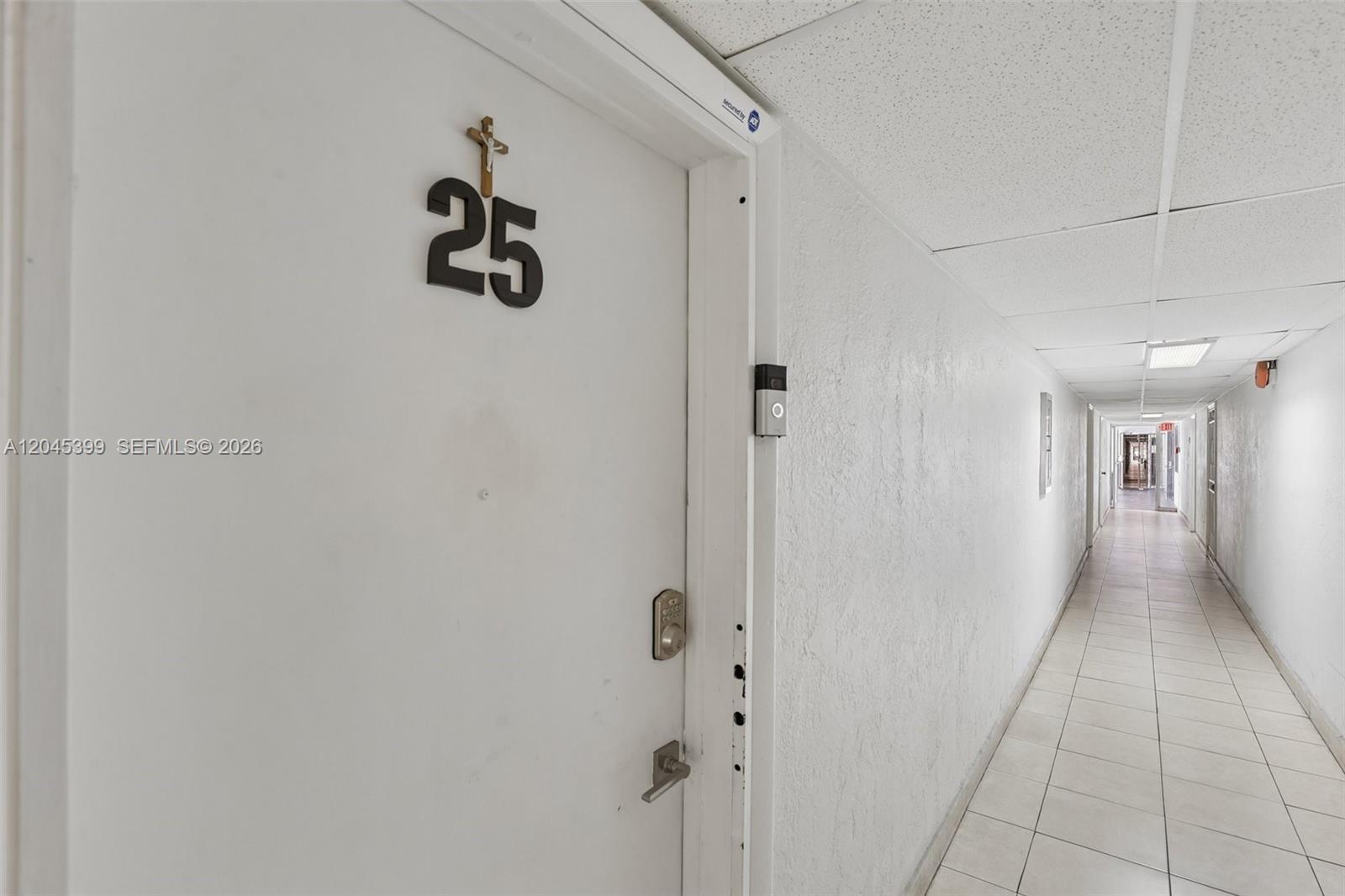 A white apartment door marked with the number 25 sits in a tiled hallway — 1300 W 53rd St # 25, Hialeah FL 33012, HIALEAH, FL