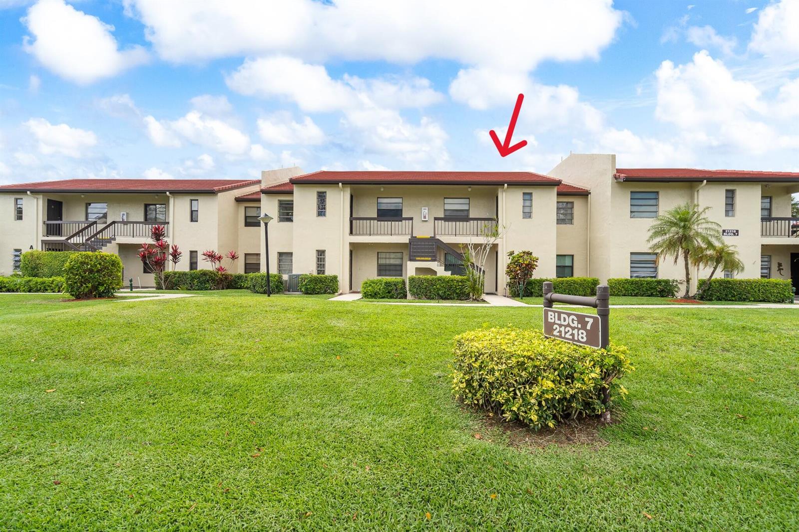 A two-story apartment building with a red tile roof and a grassy front lawn — 21218 Lago Circle # H, Boca Raton FL 33433, BOCA RATON, FL