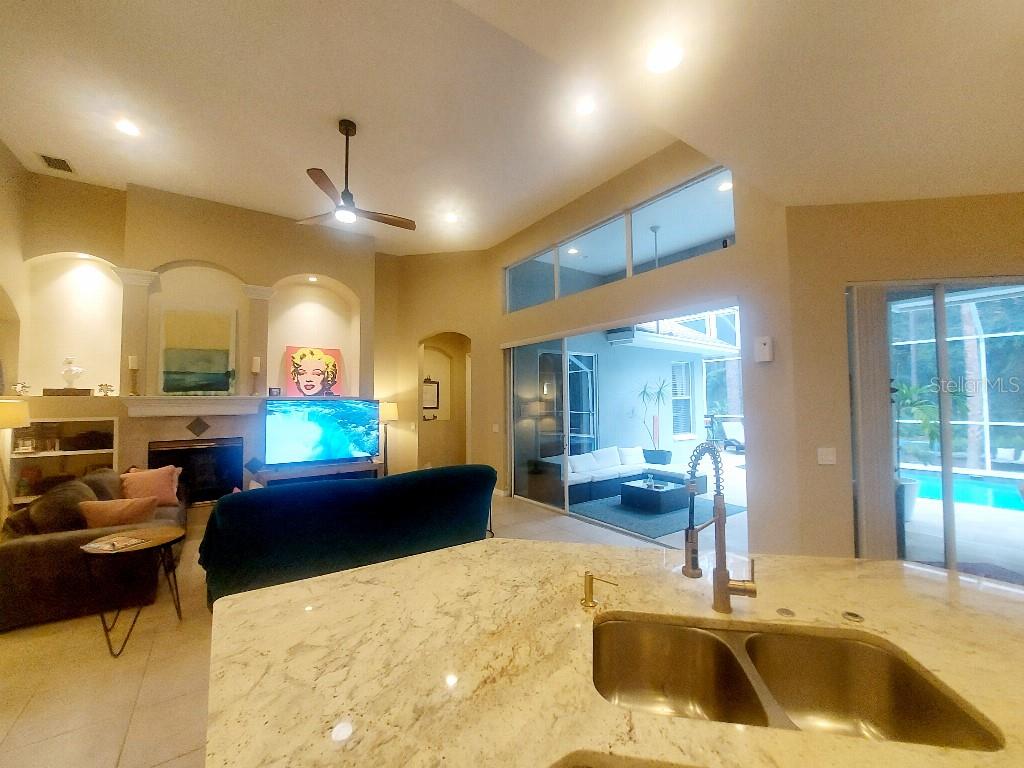 A bright foyer features a tiled floor, a staircase, and a doorway leading to an office — 9820 GRETNA GREEN DRIVE, TAMPA, FL