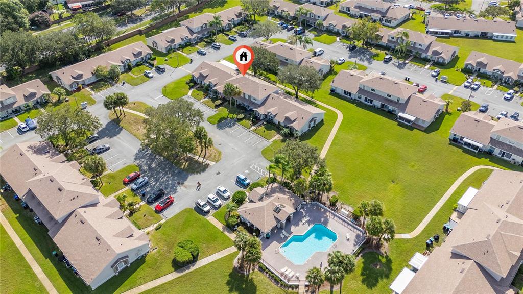 An aerial view shows a residential complex with multiple buildings, parking lots, and a swimming pool — 1220 GARDEN ISLE COURT, ORLANDO, FL