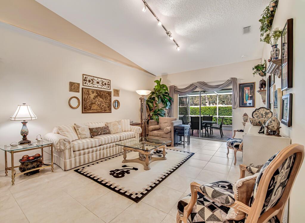 A tiled entryway features a white front door with a decorative stained glass insert — 8482 Logia Circle, Boynton Beach FL 33472, BOYNTON BEACH, FL
