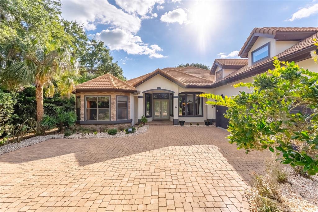 A paved driveway leads to the front entrance of a house with a tiled roof — 3 FLAGSHIP COURT, PALM COAST, FL