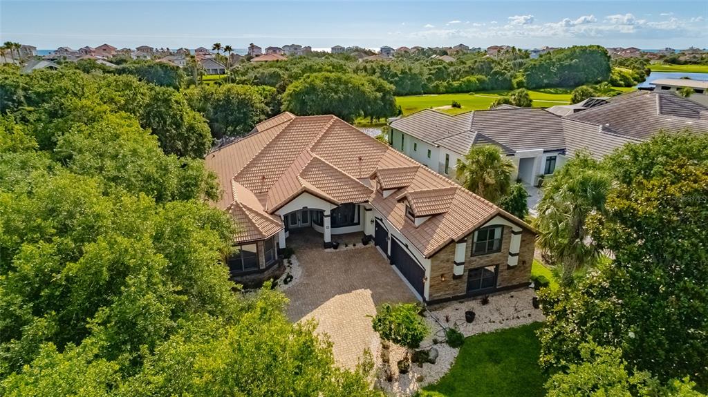An aerial view shows a single-story house with a tiled roof and a paved driveway — 3 FLAGSHIP COURT, PALM COAST, FL