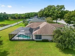 An aerial view of a house with a screened-in pool and a large backyard — 5060 SE 40TH STREET, OCALA, FL