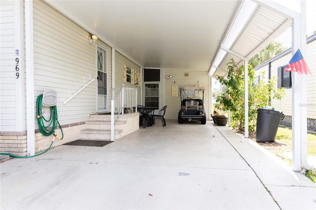 A covered carport leads to the entrance of a mobile home with light siding — 2100 KINGS HIGHWAY UNIT 969, PORT CHARLOTTE, FL