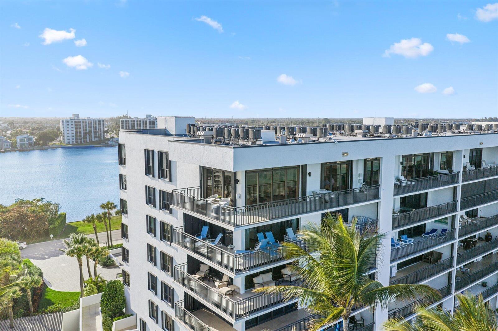 An elevated view of a sandy beach with palm trees and a wooden staircase — 19750 S Beach Road # 7050, Jupiter FL 33469, JUPITER, FL