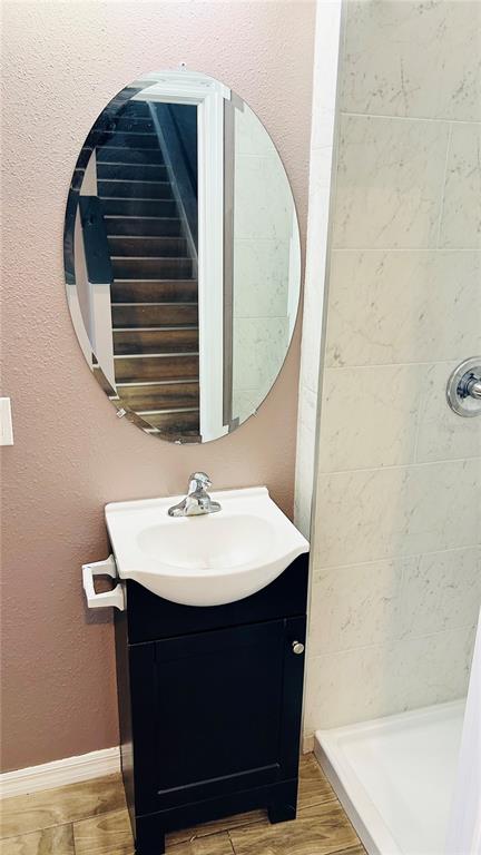 A bathroom features a black vanity with a white sink, an oval mirror, and a shower — 11152 LELAND GROVES DRIVE, RIVERVIEW, FL