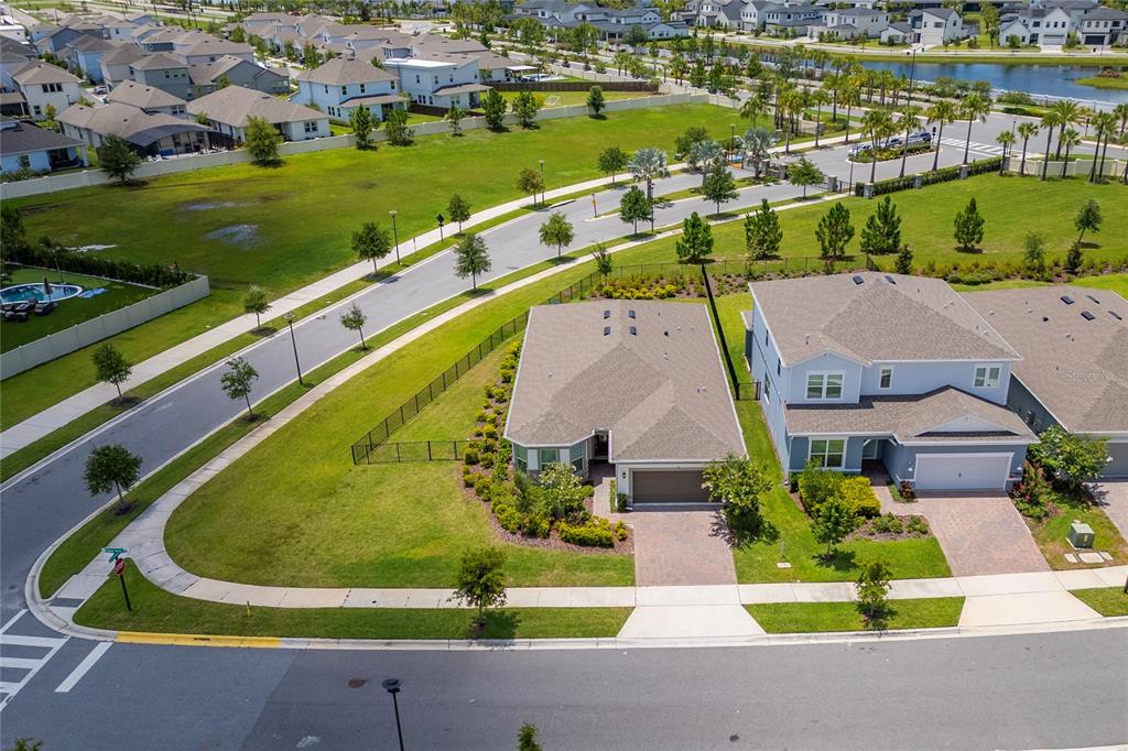 An aerial view shows two suburban houses with paved driveways next to a grassy field — 13270 PANAMA BEACH COURT, ORLANDO, FL