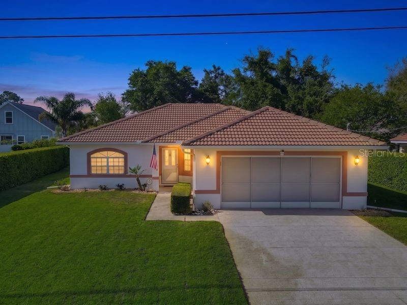 A single-story house with a tiled roof, a two-car garage, and a front lawn — 60 ROLLING SANDS DRIVE, PALM COAST, FL