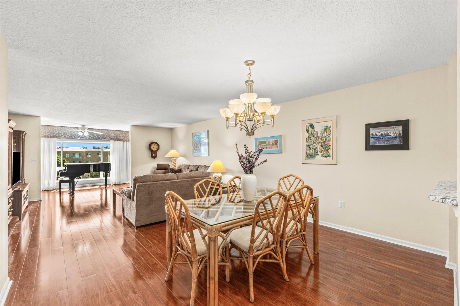 A living room features hardwood floors, a grand piano, and two brown sofas — 12560 Majesty Circle # 401, Boynton Beach FL 33437, BOYNTON BEACH, FL