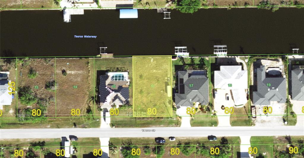 This aerial map shows a vacant residential lot situated between two houses along a canal — 15124 TAURUS CIRCLE, PORT CHARLOTTE, FL