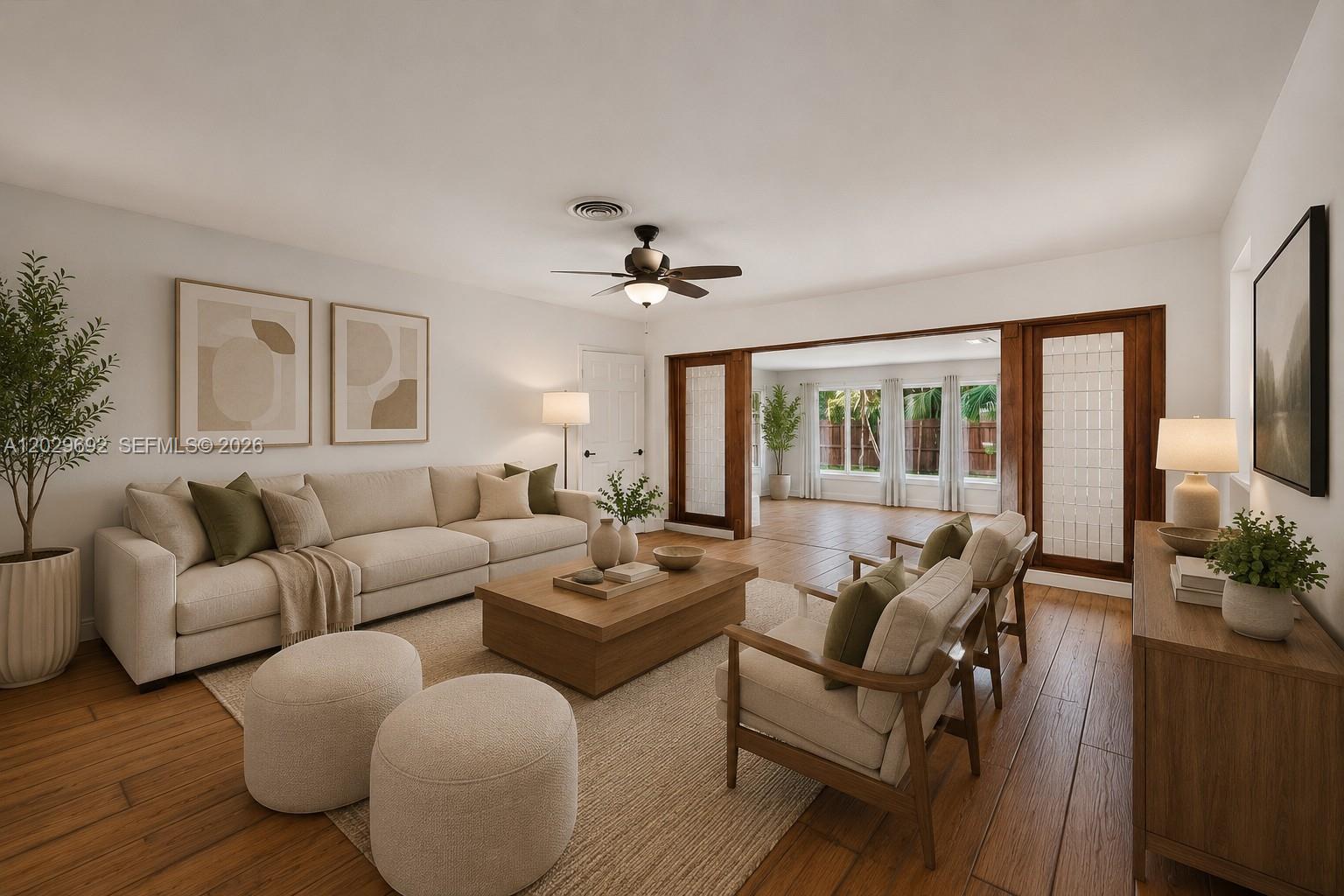 This is a digital rendering of a living room featuring neutral furniture and wood flooring — 5501 Pine Ter, Plantation FL 33317, PLANTATION, FL